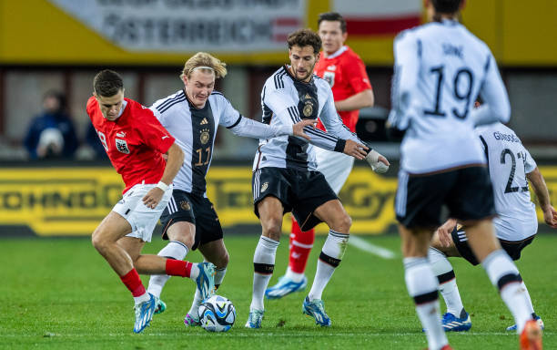 Julian Brandt of Germany is challenged