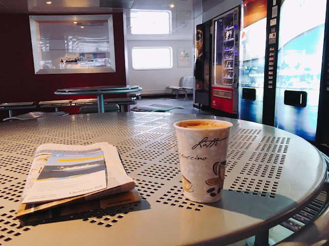 coffee and newspaper inside the the Lévis Ferry