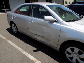 Damaged Camry before collision repair at Almost Everything Auto Body.