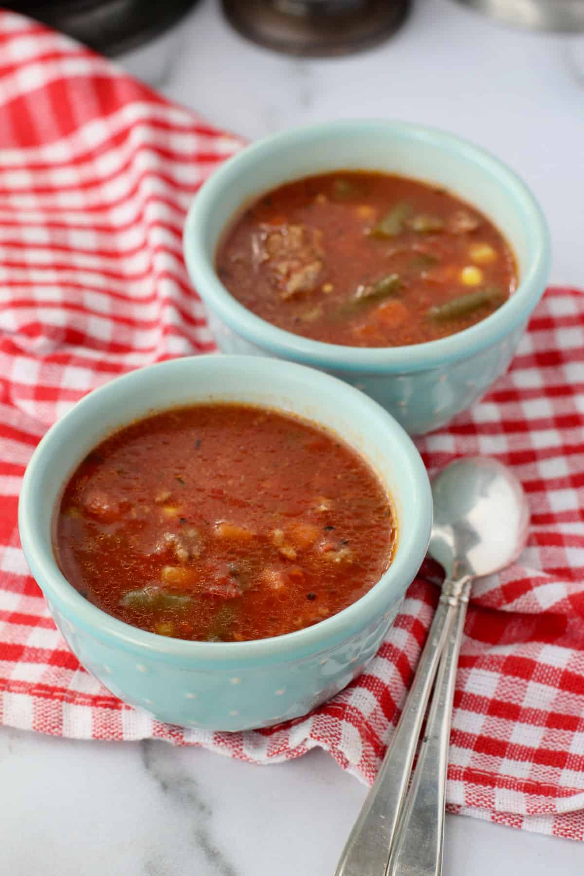 Easy Slow Cooker Beef and Vegetable Soup in blue bowls.