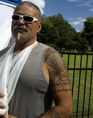 A Maori vendor proudly wears his moko (tattoos). The moko tell the ancestral 