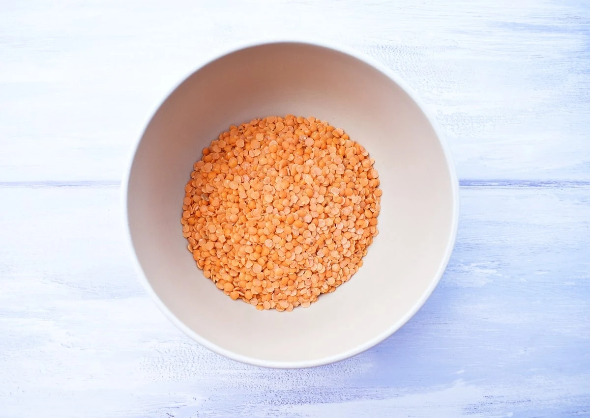 uncooked red lentils in a bowl.