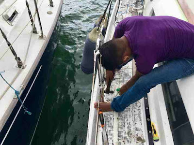 Strippng the old teak deck off a Jeanneau yacht