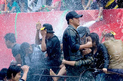 Young people are sprayed with water during the annual â€˜water festivalâ€™ in Yangon, Myanmar.