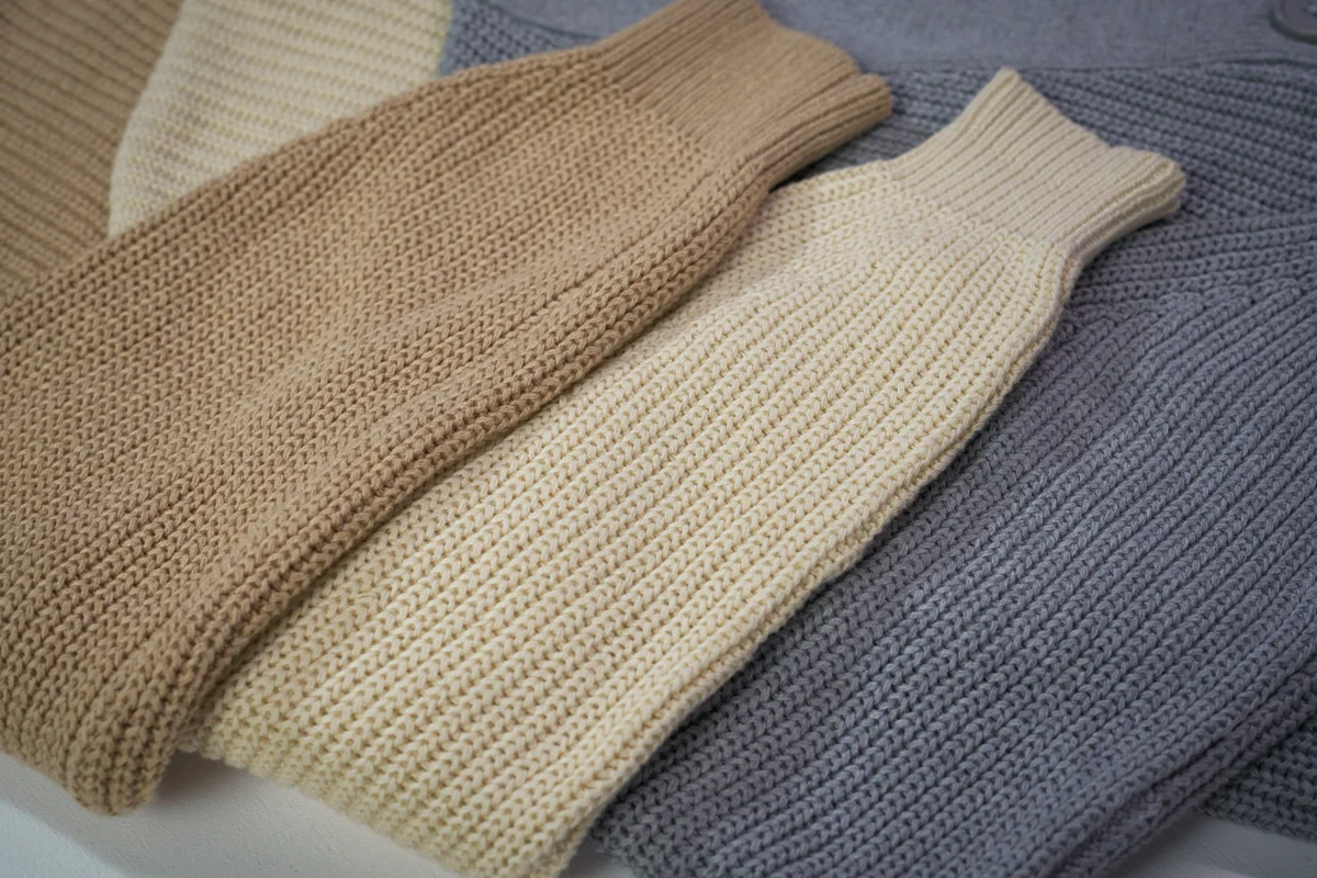 close-up studio picture of three folded sweaters