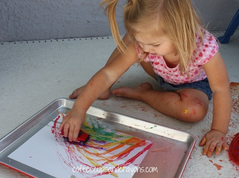 toddler painting with cars