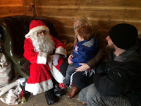 Mummy, Daddy and son talking to Santa