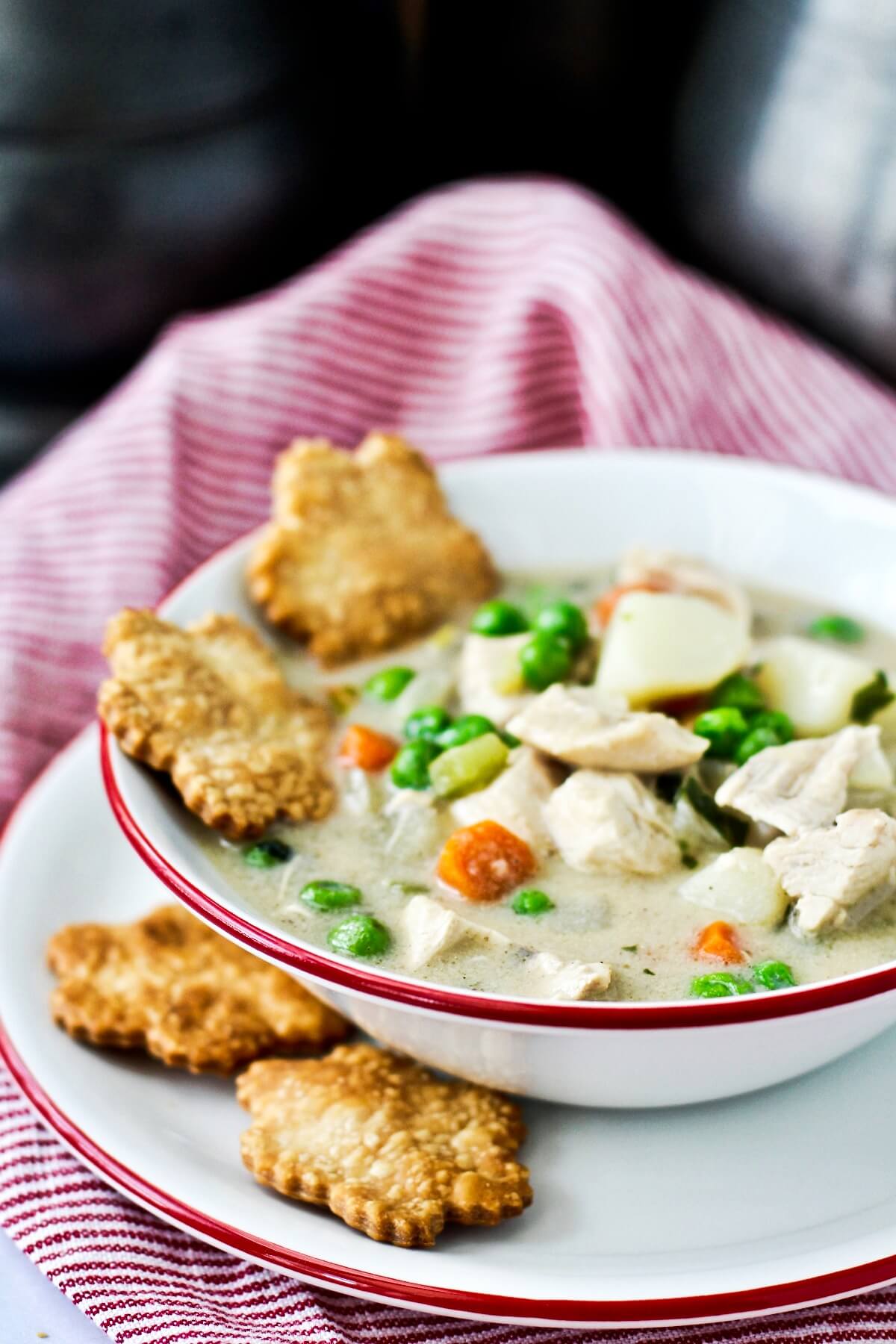 Chicken Pot Pie Soup with Pie Crust Crackers in the bowl.