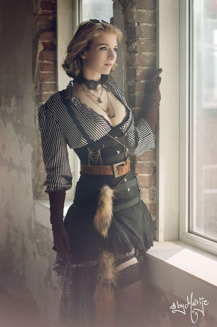 women's steampunk clothing inspiration. Striped blouse, black short skirt, black corset, sheer thigh high stockings and elbow length gloves.