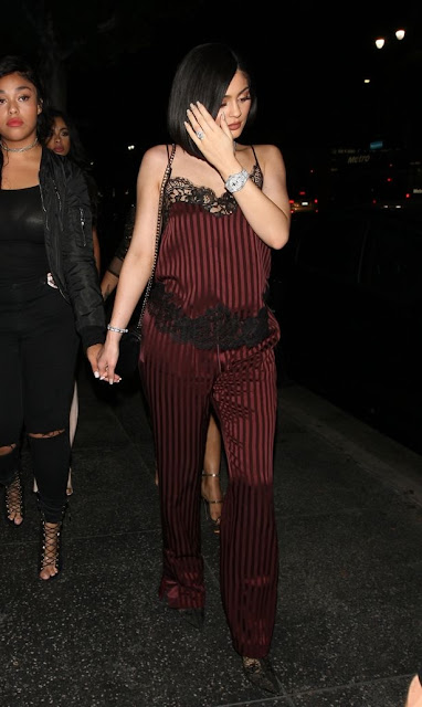 Kylie Jenner continues to show off her HUGE diamond 'engagement ring' as she steps out in a jumpsuit