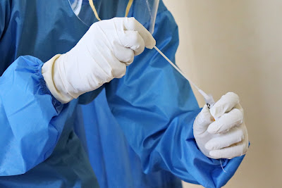 Mufid Majnun: Laboratory worker takes a swab test, via Unsplash at https://unsplash.com/photos/oI20ehIGNd4