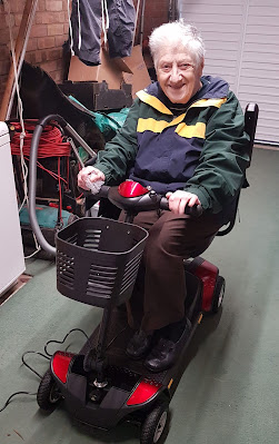 Mum on the mobility scooter in the garage