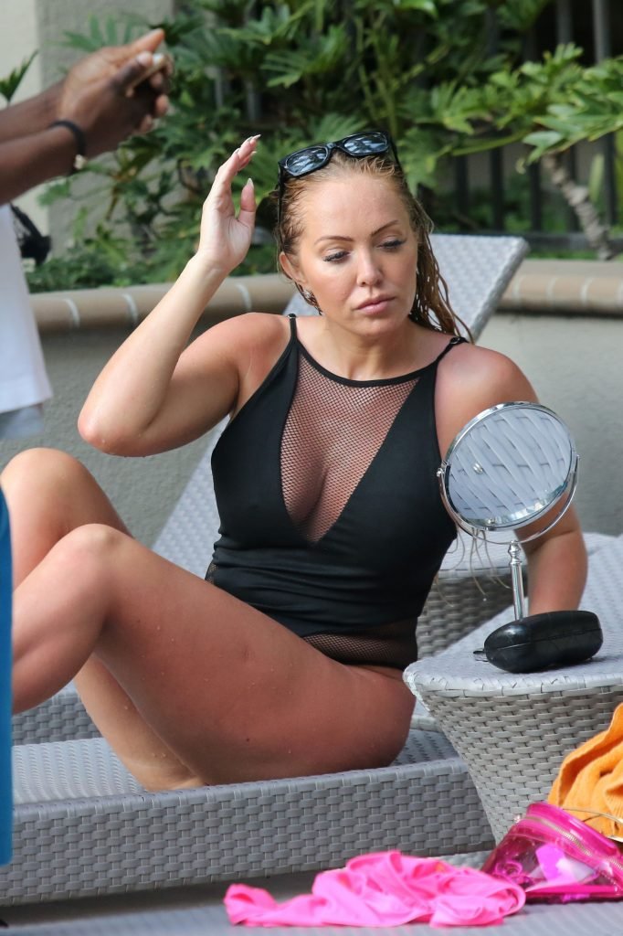 Aisleyne Horgan-Wallace goes topless as she strips almost completely naked for steamy poolside shower.