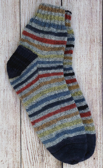 Top-down vanilla socks knitted with Patons Kroy Blue Stripes Ragg and DROPS Fabel Deep Ocean