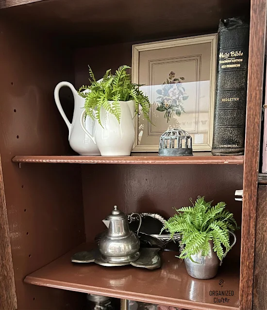 Photo of neutral decor in a vintage secretary cabinet.