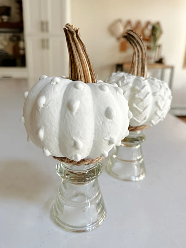 hot glue pumpkins on pedestals with real stems