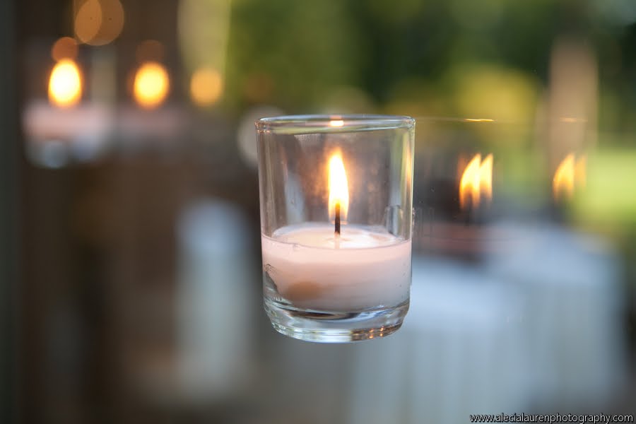 Rooms in Bloom hung tea lights in glass containers to the wall of windows 