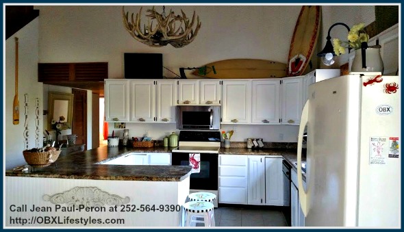 The kitchen of this 4 bedroom canalfront OBX NC home for sale has plenty of cabinets and shelves which can accommodate all of your kitchen storage needs.