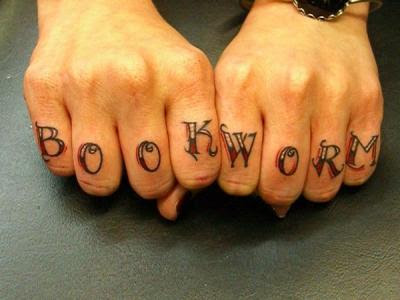 Book worm knuckle tattoo.