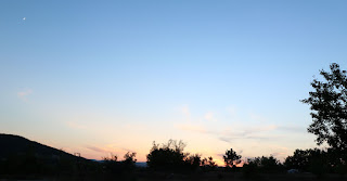 The moon top left, as the sun disappears