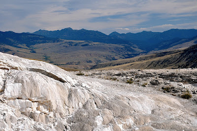 distant mountains provide backdrop to hot springs features