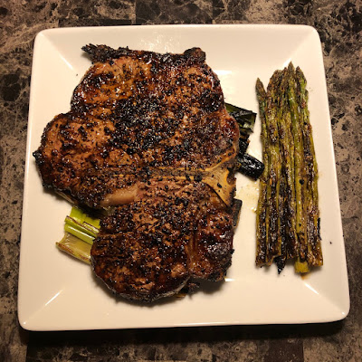 Rare grilled porterhouse, grilled leeks and asparagus