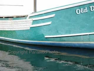 minimalist photograph blue white boat with yellow rope