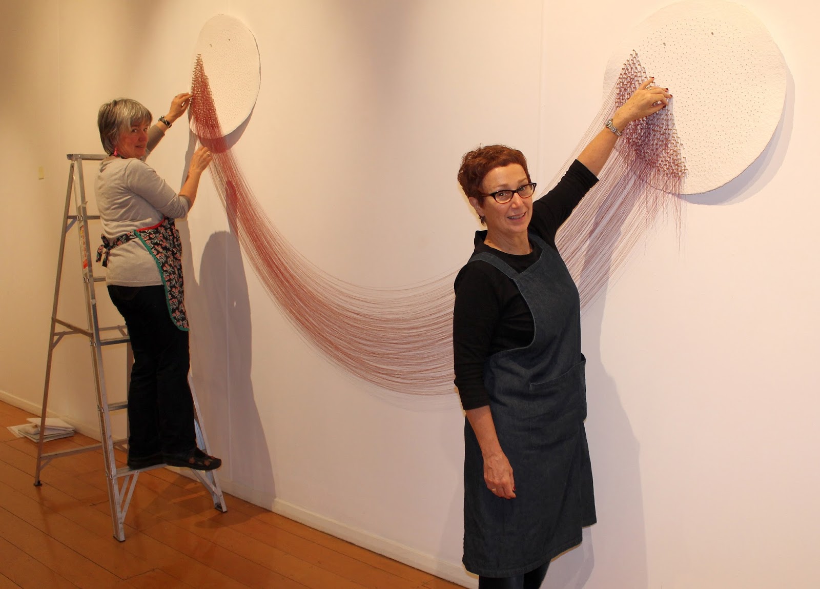 Michelle Elliott installing her artwork, 'hemispheres, drawn to you ...
