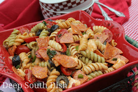 ri-color rotini pasta is paired with some of my favorite pizza toppings, purple onion, green and red bell pepper, black olives, pepperoni, bacon, mushrooms, grape tomatoes and mozzarella and dressed with a spicy tomato dressing.