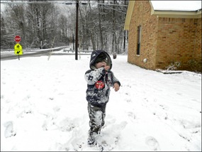 Yes he is licking snow off his arm.