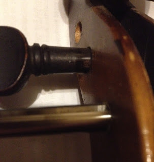 Detail of violin peg hole reaming and worn peg hole