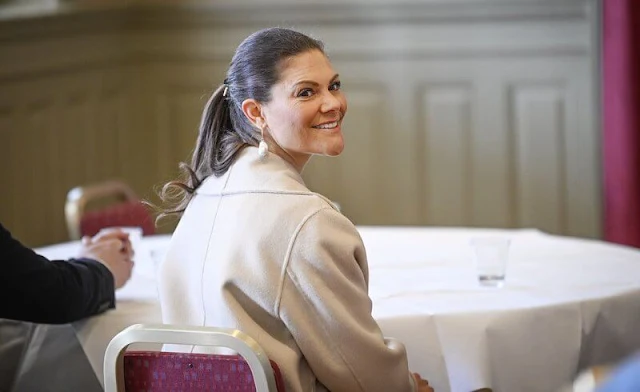 Crown Princess Victoria wore a maygen top, and a schain skirt by Baum und Pferdgarten, and a beige Robe belted wool coat by Toteme