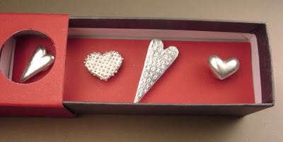 four pewter heart magnets