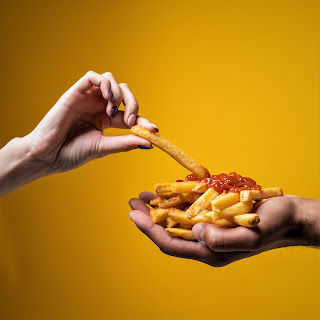 people eating french fries with ketchup