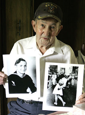 Glenn McDuffie holding to a photograph of the iconic image