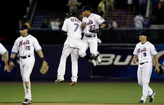 Jose Reyes and Carlos Gomez celebrate a Mets victory