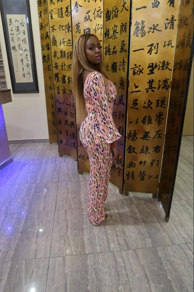 Billionaire daughter, Dj Cuppy poses in jumpsuit beside her bullet proof G-Wagon