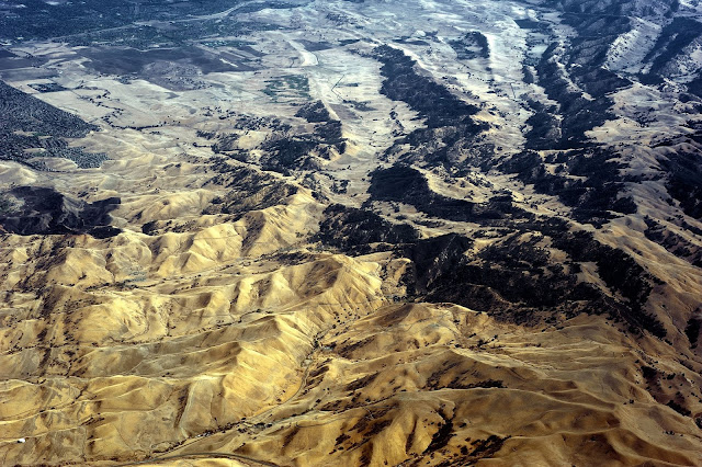 Shot from a plane, this photo shows mountain rangers, valleys and small towns.