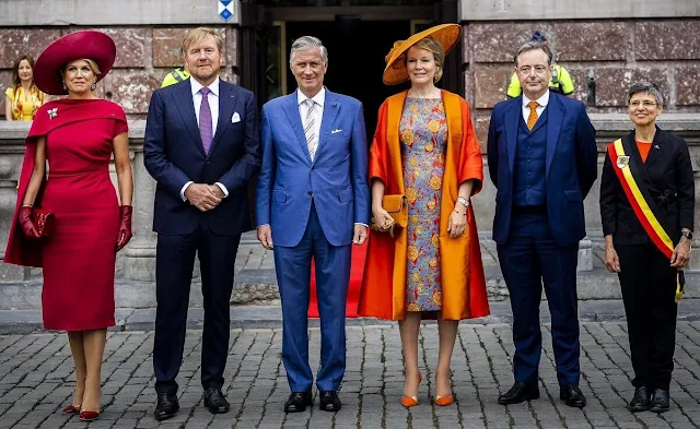Queen Maxima wore a red midi dress by Natan. Queen Mathilde wore a metallic floral jacquard midi dress by Dries Van Noten