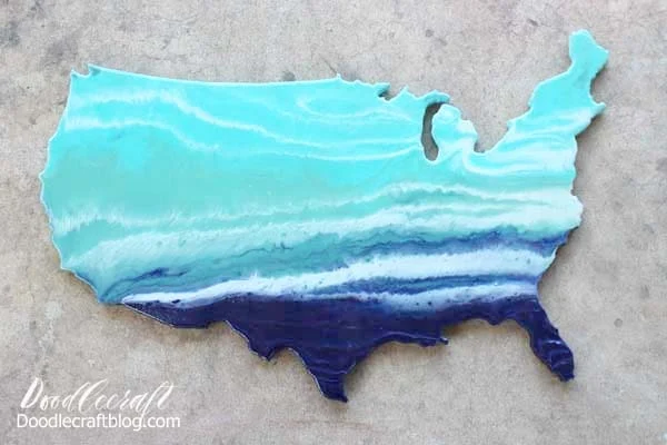 How to do an Ocean Resin Pour on USA Cutout DIY tutorial to make home decor look like the waves of the ocean in ombre shades of blue.