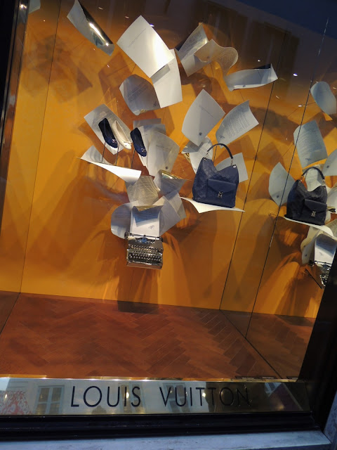 Louis Vuitton window display with typewriter and accessories.