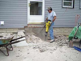 Working to remove broken cement steps