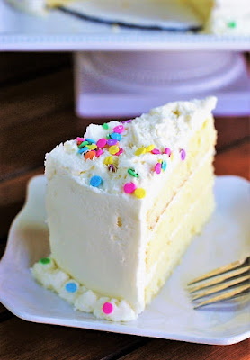 Slice of White Chocolate Birthday Cake with White Chocolate Frosting Image