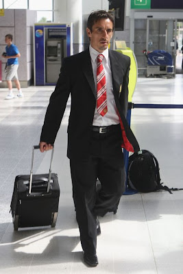 Skipper Gary Neville arrives at the airport and is swiftly followed by...