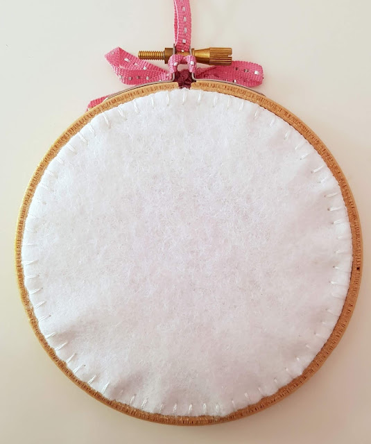 Baby name cross-stitch in an embroidery hoop