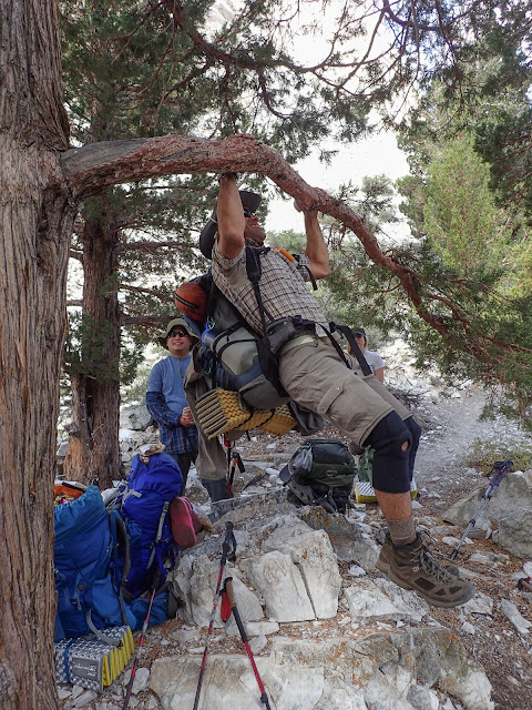 Victor doing a pullup with a full pack