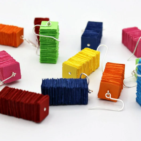 colorful assortment of square paper disc earrings with silver wires.