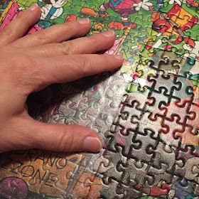 Process of applying contact paper to the surface of a large puzzle