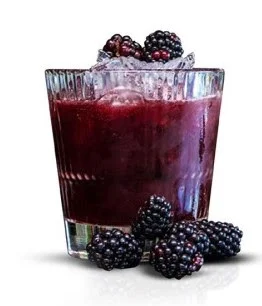 Purple Stag Cocktail in a short glass with fresh blackberries