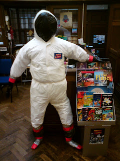 A spaceman stands beside the counter at Burley Library